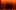 Dancers sit facing a stage backdrop of swirling black shapes on a bright orange background, creating a hypnotic, tunnel-like visual effect.